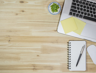 Top view of laptop with on wooden table.