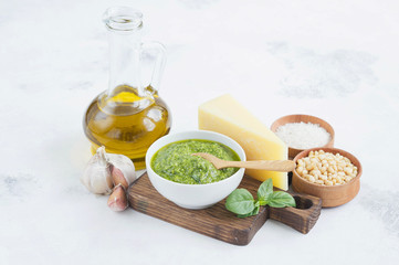 Ingredients for pesto on a white background. The finished pesto