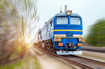 Locomotive in the composition of a passenger train in motion at speed.