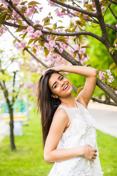 beautiful young woman take photo with blooming cherry blossoms sakura flowers