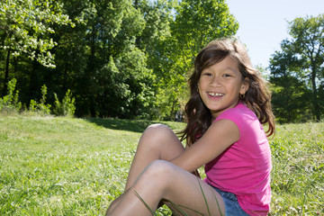 Naklejka na ściany i meble smiling happy young girl on the grass garden