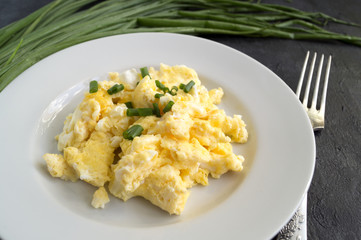 scrambled eggs on a white plate. the view from the top.