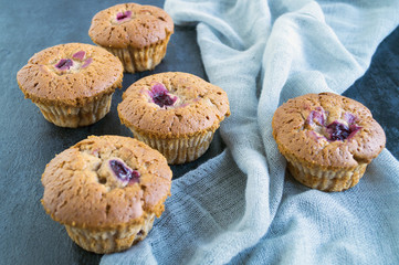 homemade cakes with cherries on a black background