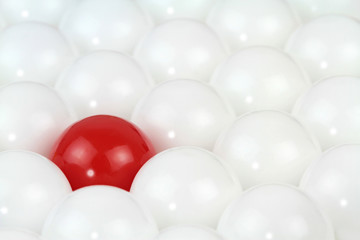 Difference concept, red ball in white balls. Conceptual image.