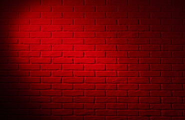 Fototapeta na wymiar dark red brick wall with light effect and shadow, abstract background photo