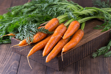fresh carrots bunch on rustic wooden background