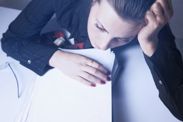 tired and exhausted woman working with documents (psychological portrait, aggression, anger,...