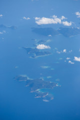 Fototapeta na wymiar View from the wing of the aircraft to the islands of Philippines