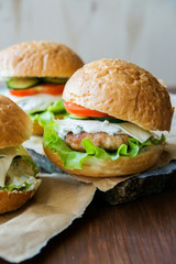 Closeup of home made burgers on wooden background