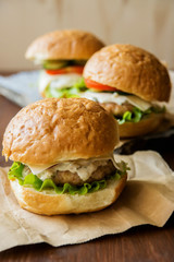 Closeup of home made burgers on wooden background