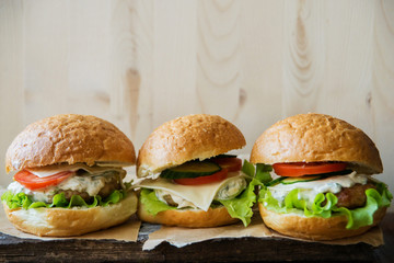 Closeup of home made burgers on wooden background