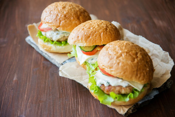 Closeup of home made burgers on wooden background