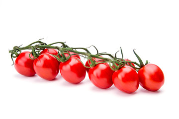Branch of ripe cherry tomatoes over the white background