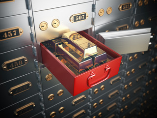 Open safe deposit box with  golden ingots. Financial banking investment concept.