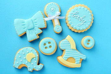Baby cookies decorated with glaze on color background