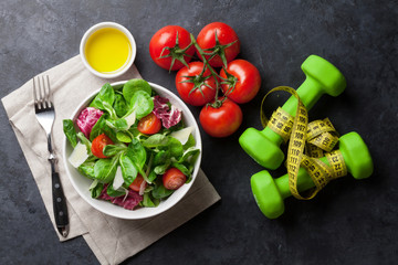Healthy salad and fitness equipment