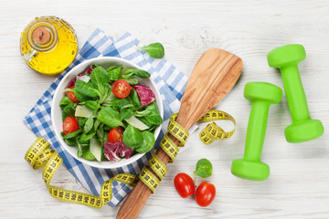 Healthy salad and fitness equipment