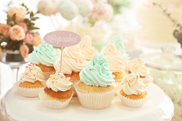 Stand with tasty cupcakes prepared for party