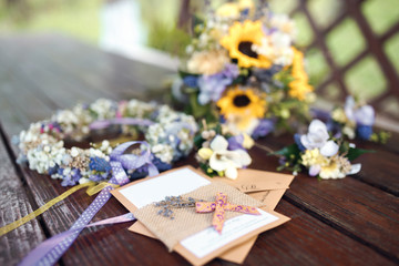 Naklejka na ściany i meble Closeup shot of the wedding bouquet, wreath and invitations at daylight