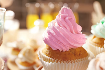 Tasty cupcake on blurred background, closeup