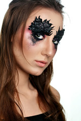 Girl with paper zigzag make-up and brown hair.Creative makeup.White background
