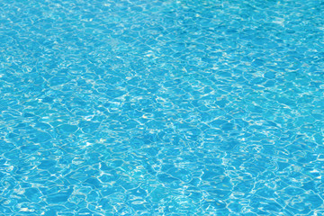 Blue and bright ripple water and surface in swimming pool , Beautiful motion gentle wave in pool