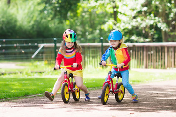 Fototapeta premium Kids ride balance bike in park