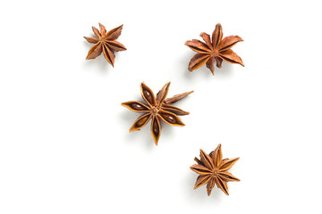 Star anise, scattered in a chaotic manner, isolated on white background
