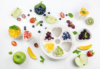 Automatic yogurt maker with fruits on white background
