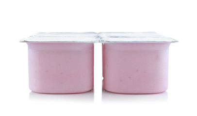 Plastic cups with yogurt on white background