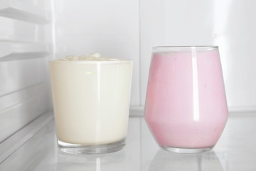 Glasses with yogurt standing in fridge