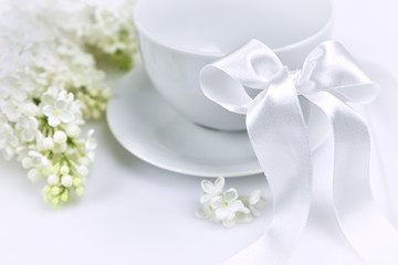 White lilac with white cup and a ribbon