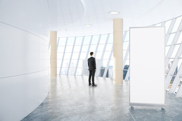Fototapeta premium Man and empty ad stand