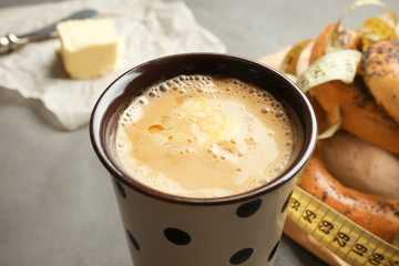 Cup of tasty butter coffee on grey table, closeup