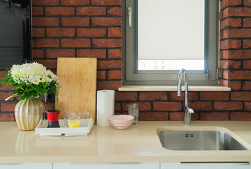 kitchen table top with sink and washed plates