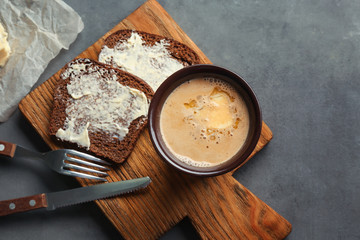 Composition with tasty butter coffee on grey table