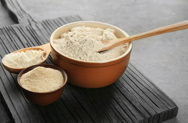 Composition with flour on grey textured table