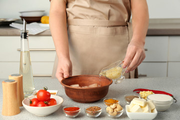 Obraz na płótnie Canvas Woman cooking Murgh Makhani in kitchen
