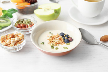 Composition with tasty yogurt on kitchen table