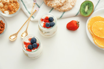 Composition with tasty yogurt and different products on table