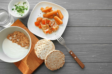 Composition with tasty yogurt and different products on table