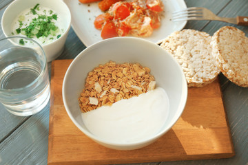 Composition with tasty yogurt and different products on table