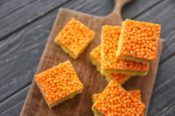 Multicolored crispy dessert on wooden background