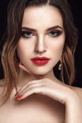Beautiful woman portrait with smokey eyes and red lips.