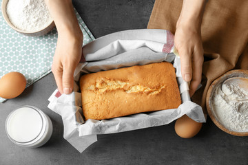 Woman holding baked pie in baking dish