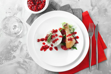 Portion of rice and chicken with cranberry sauce on plate