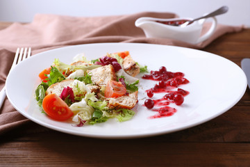 Portion of salad and cranberry sauce on plate