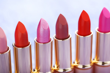 Obraz premium Colorful lipsticks on a paper background