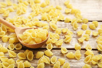 Pasta penne on the brown wooden table