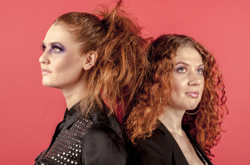 Naklejka premium Two young red-haired girls in bright make-up 